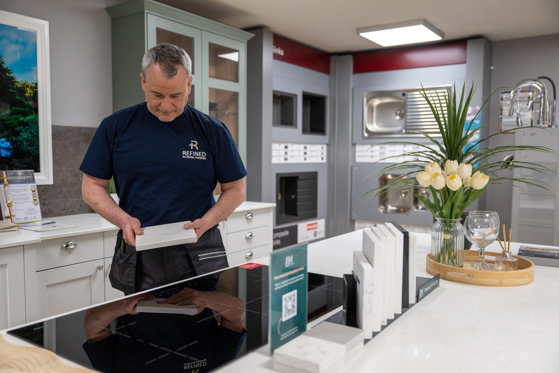 A fitter checking worktop samples in a showroom